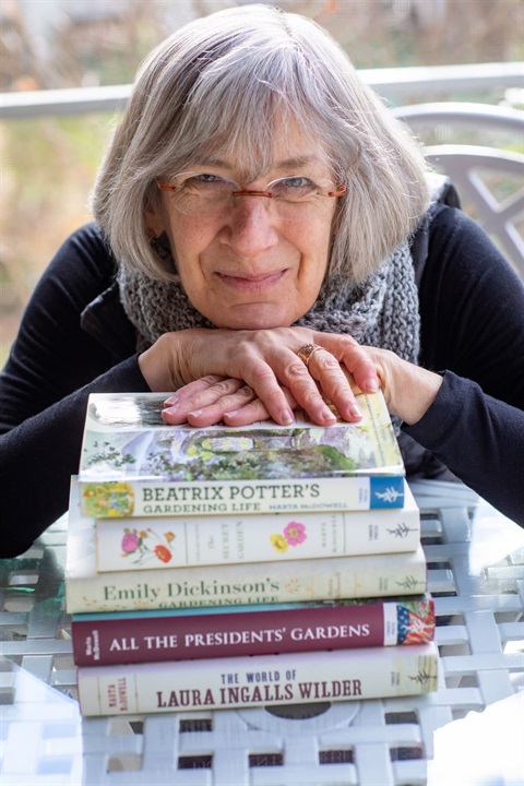 Author Photo McDowell with Books, compressed, credit Sarma Ozols.jpeg