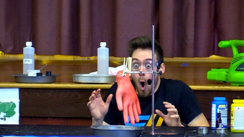 man doing science experiment with glove